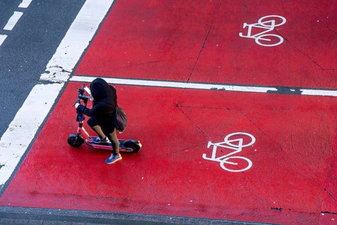 E-scooter, e-scooter on bicycle lane, parking area for cyclists at a traffic light crossing, marked