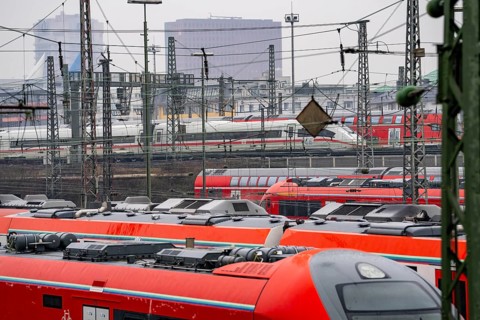 Railway tracks with regional trains and long-distance trains, ICE, after freezing rain, in front of