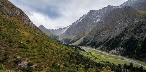 Green mountain valley with river and steep mountain peaks, Chong Kyzyl Suu Valley, Terskey Ala Too,