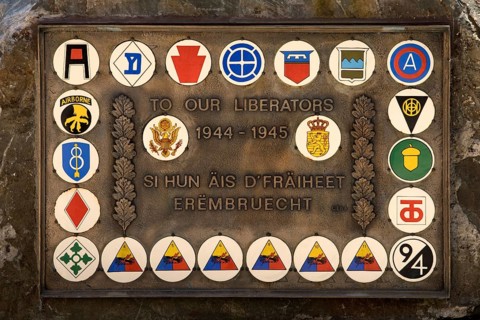 Liberation memorial with the inscription Unseren Befreiern 1944 - 1945 with coats of arms of
