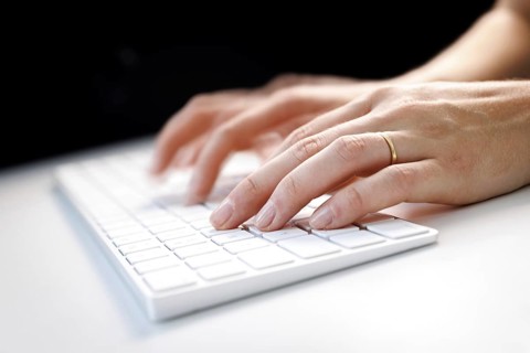 Hands typing on a keyboard in Berlin, 09/08/2024
