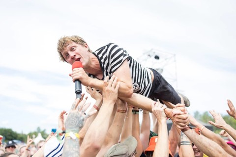 Beat Schmutz, singer of the band Schmutzki crowdsurfing on the beach in front of the Becks Beach