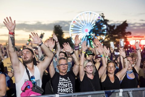Festival visitors illuminate the site with mobile phone lights at the Highfield Festival on Friday,