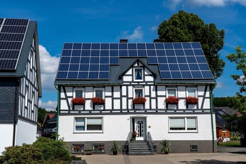 Half-timbered house with a solar roof, solar modules on the pitched roof, near Bad Berleburg, North