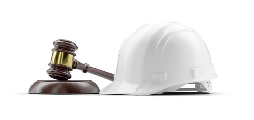 White hard hat and gavel isolated on a white background