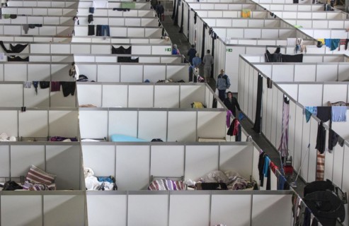 Temporary rooms with beds are set up in an emergency shelter for refugees on 9 December 2015 in a