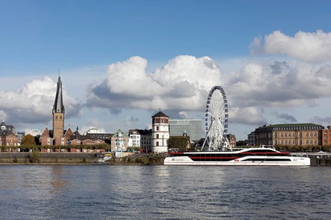 Rhine bank with St. Lambertus, castle tower and Ferris wheel, KD event ship MS Rheingalaxie,