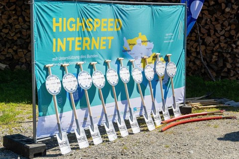 Advertising banner for high-speed Internet with shovels lined up and piles of wood in the