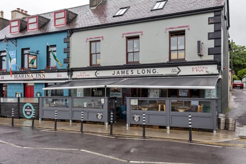 Historic pub front with modern awning, Dingle