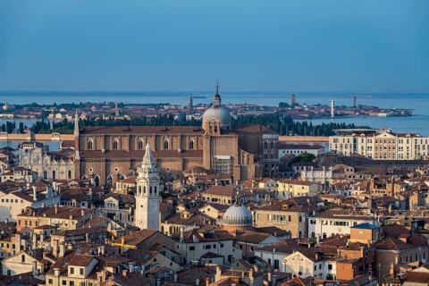View over the roofs of Venice to the church Basilica dei Santi Giovanni e Paolo in the evening