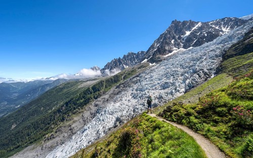 Hiking on the trail to La Jonction, Glacier des Bossons, behind the summit of the Aiguille du Midi,