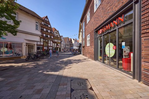 Pedestrian zone Lange Straße with a branch of the drugstore Rossmann, retail shops and