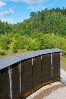 Curved wooden Kneipp wall in the middle of a wooded landscape, brine, graduation tower, spa town of