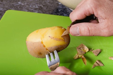 German cuisine, preparation of sauerbraten with mashed potatoes, jacket potatoes, peeling boiled