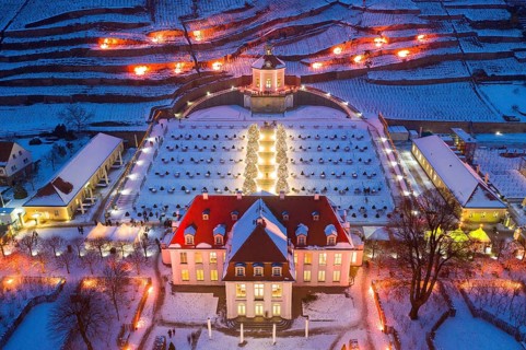 Aerial view of Wackerbarth Castle with castle park, belvedere and vineyards with snow and Christmas