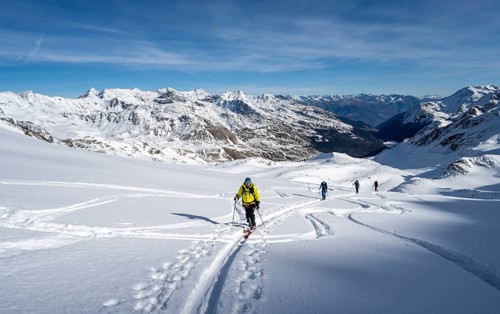Ski tourers ascending Monte Cevedale, mountain panorama, snow-covered mountain landscape in winter,