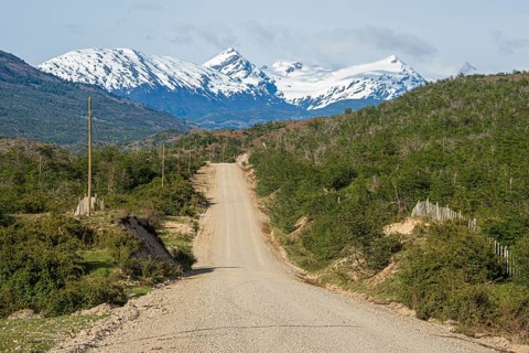 Road Carretera Austral north of Cochrane, gravel road in front of snowcovered mountains, Patagonia,