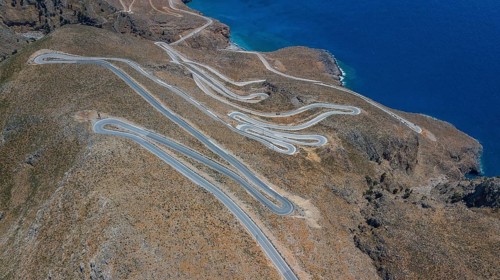 Aerial view of pass road serpentines from to Passo Anopoli above south coast of Crete right Libyan