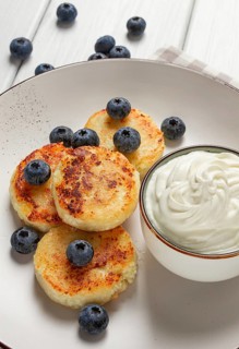 Cottage cheese pancakes, with blueberries, breakfast, on a white wooden table, no people, top view