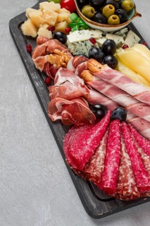 Appetizer, assortment, set, sausage, and cheese, on a wooden board, top view, no people
