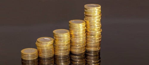 Stacked one-euro coins as a symbolic image for finance, inflation, etc