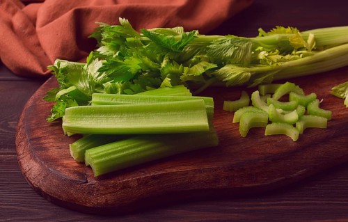 Fresh bunch of celery, top view, no people, on a dark background