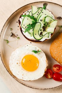 Assortment of sandwiches, white bread, fried egg, cream cheese and cucumber, capelin caviar, sesame