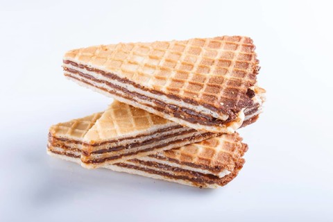 Waffle sandwiches with boiled condensed milk isolated on white background. closeup