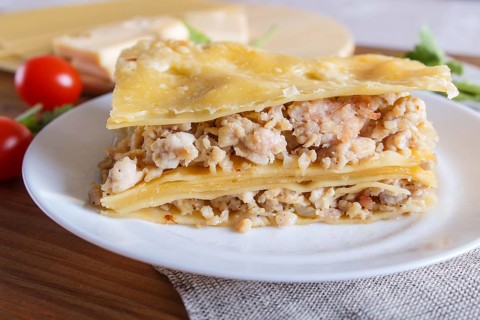 Lasagna with minced meat and cheese on brown wooden background. close up