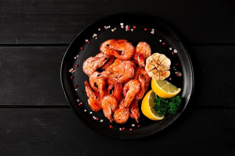 Fried shrimp, on a black background, top view, no people