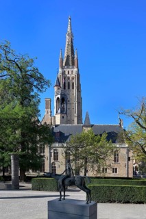 Church of Our Lady and the statue of one of the Four Horsemen of the Apocalypse, Bruges, Flanders,