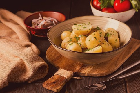 Fresh Cooked, new potatoes, with dill, on a wooden table, selective focus. close-up, toning, no