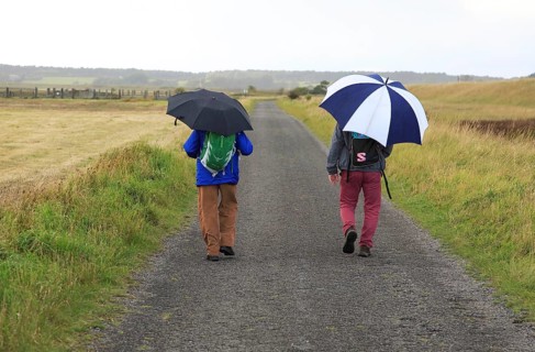 Orford Ness lighthouse Open Day, September 2017, Suffolk, England, UK, two men walking in rain