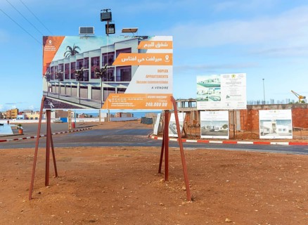 Estate agent real estate advertising sign for new duplex apartments, Mirleft, southern Morocco,