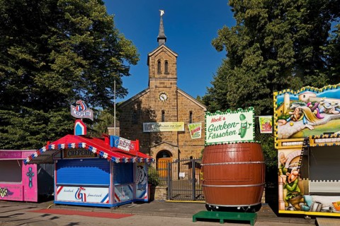 Cranger Kirche between closed fairground stalls in the morning, Cranger Kirmes, Herne, Ruhr area,