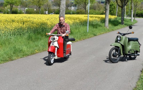 Man rides a Troll 1 vintage scooter in spring