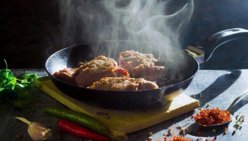 Delicious meat stakes cooked on a pan. Wooden cutting board with spices and oil, AI generated