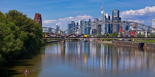 The river Main with regional railway on the Deutschherrnbrücke and the skyline of Frankfurt am