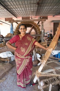 Indian worker, 59 years old, in the spinning mill of the Labourers Coir Mats and Mattings
