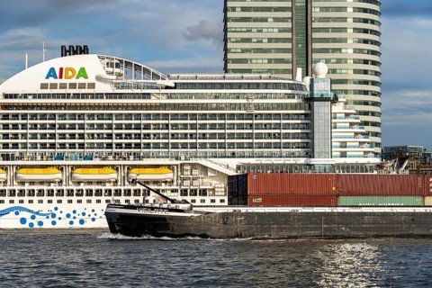 Cruise ship Aida Prima at the Cruise Terminal of Rotterdam, Kop van Zuid, high-rise buildings at