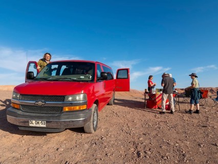 Red car, Chrysler van and travelling group at camping breakfast in Atacama Desert, Chile, South