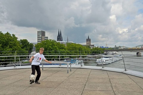 A ten-year-old boy playing with his football, viewing platform of the Chocolate Museum, Cologne,