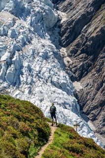 Mountaineer on a hiking trail in front of a glacier, glacier tongue Glacier de Taconnaz, Chamonix,