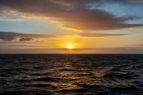 Peaceful sunset over the sea with bright orange sky and clouds, Celtic Sea