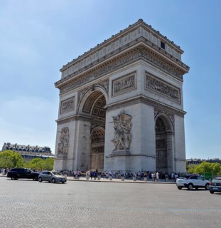 The Arc de Triomphe with clear view and blue sky, cars in the foreground, Paris