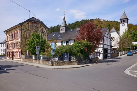 Crossroads with half-timbered houses and Church of the Redeemer in Adenau, Eifel, Ahrweiler