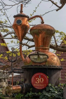 Distillery, distilling apparatus as an advertisement in front of a distillery, Lower Franconia,