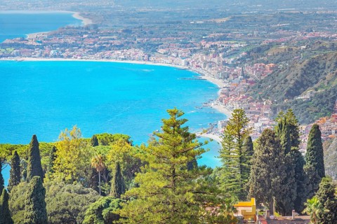 View of the Ionian coast and Giardini di Naxos in the distance, Taormina, Sicily, Italy, Europe