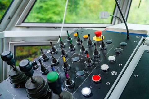 Control panel in bright surroundings, several levers and buttons in different colours, Hermann