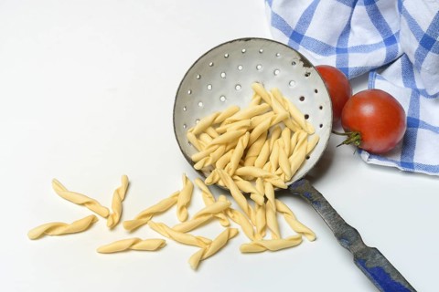 Strozzapreti, uncooked Italian pasta in a sieve, Italy, Europe